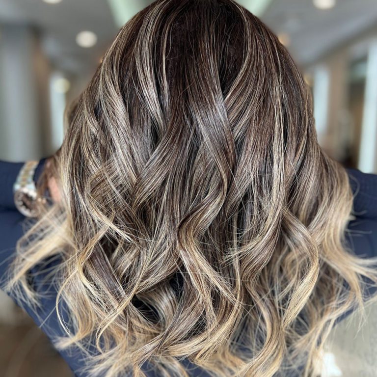 Golvend haar met een balayage van donker naar blond